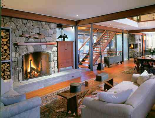 A roaring fire in the living room supplements the home’s in-floor radiant heating. “We love the warmth and atmosphere of our wood fireplaces,” Sally says.
